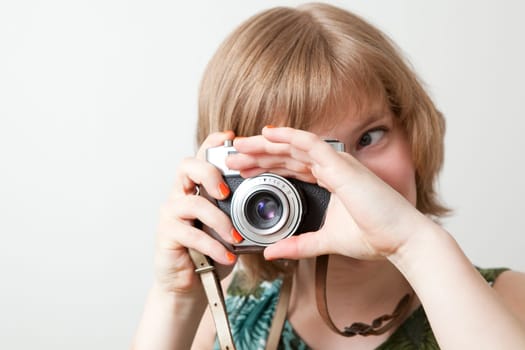 Young woman holding an old vintage camera
