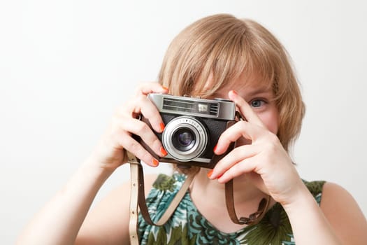 Young woman holding an old vintage camera