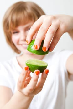 Young woman with fresh lime. Studio shot.