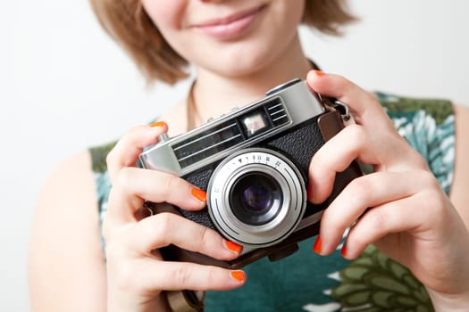 Young woman holding an old vintage camera