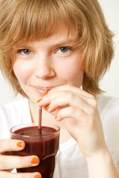 Young beautiful woman drinking a blueberry smoothie
