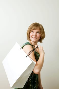Young woman carrying a shopping bag on her shoulder