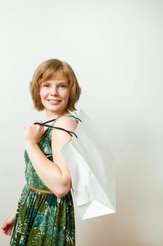 Young woman carrying a shopping bag on her shoulder