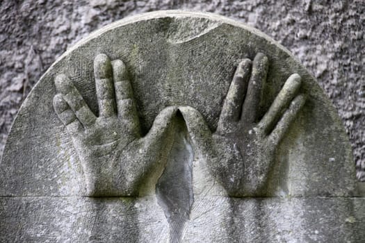 Hands on a Jewish gravestone