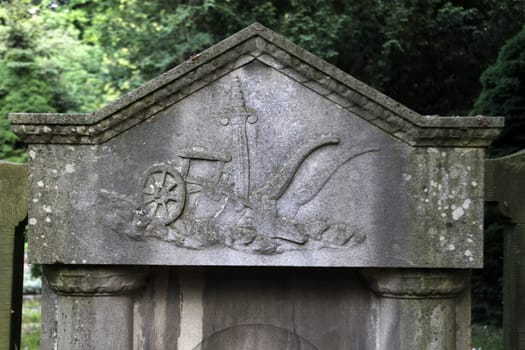 Gravestone with sword and plow