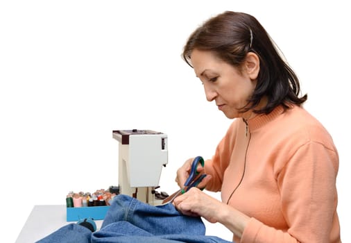 Experienced seamstress at work,studio shot,isolated on white