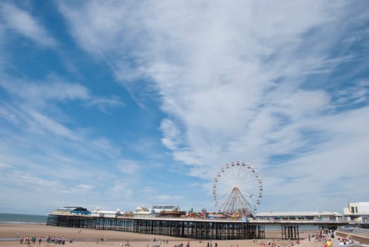 Central Pier Blackpool showing the Fairground Wheel under a summer sky
