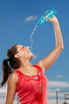 Young woman splashing herself with water