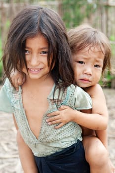 Children from Asia,especially in Laos,live with dirty clothes and no chance of education