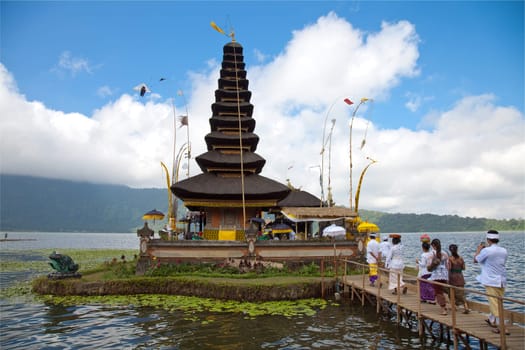 People arriving for a ceremony at Pura Ulun Danu temple in Bali Indonesia