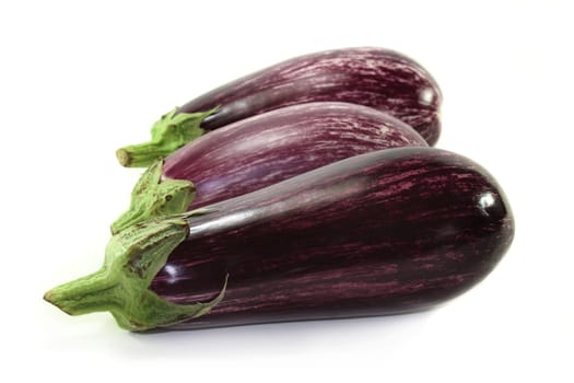 three eggplants against a white background