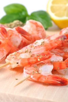 shrimps,lemon and basil on board isolated on white background