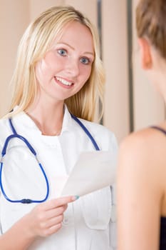 woman doctor giving prescription to patient