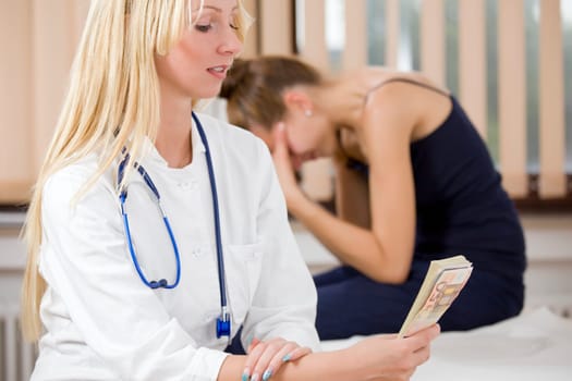 paying for medical treatment - woman doctor holding money from ill patient. Without cash no medical help concept.
