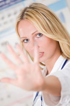 young woman doctor showing stop gesture