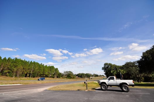 countryside road with a single truck at the side