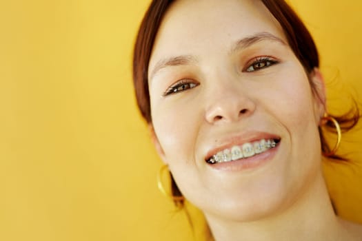 portrait of young caucasian college student with braces, smiling at camera. Selective focus, copy space
