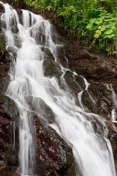 a beautiful waterfall on a mountain slope