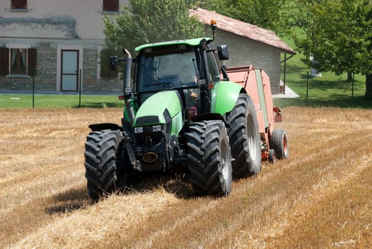 tractor in a field of freshly cut wheat