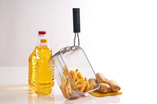 deep-fried french fries with scalloped cut in fryer basket