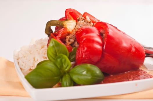 stuffed red peppers with rice and herbs served on plates