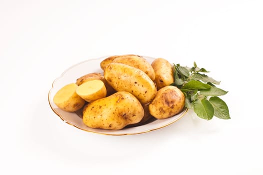 fresh potatoes on porcelain plate