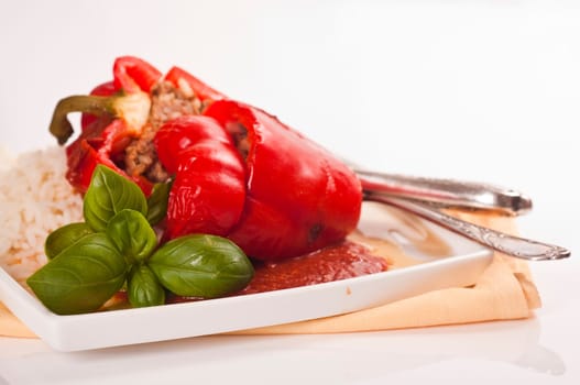 stuffed red peppers with rice and herbs served on plates