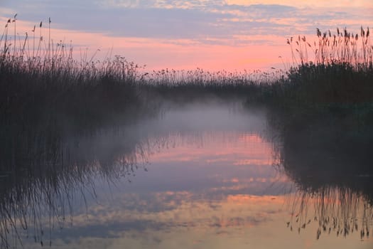 reflection of clouds on the lake at sunrise