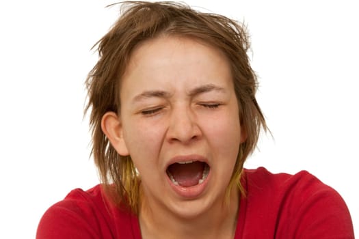 Young woman yawning - isolated on white background