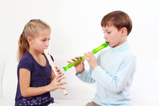 Cute kids playing flute together