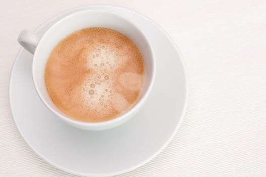 Espresso Coffee in White Cup on Light Tablecloth