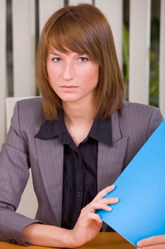 portrait of businesswoman holding a file in office