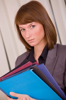 portrait of young businesswoman with files