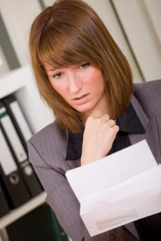 woman reading a letter with bad news