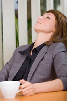 coffee break in office - relaxing woman with cup tea