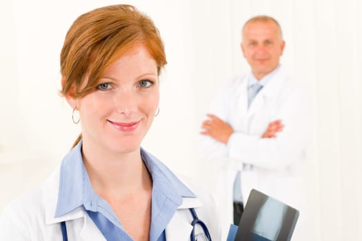 Medical doctor team young woman holding x-ray senior male colleague