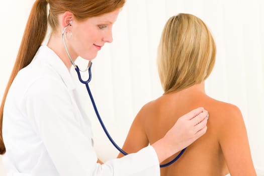Medical professional doctor with stethoscope examine woman patient naked back