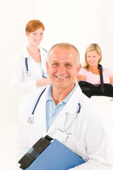 Two medical doctors professional with hospital patient lying in bed