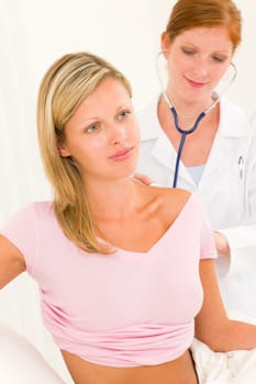 Medical professional female doctor with stethoscope examine woman patient back