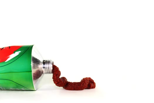 a tube of tomato paste against a white background