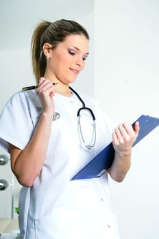 beautiful doctor in a hospital is writing and working