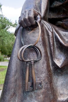Element of a bronze sculpture. The hand holds two keys.