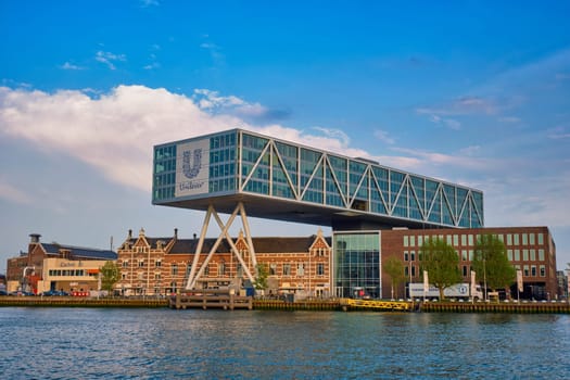 ROTTERDAM, NETHERLANDS - MAY 11, 2017: Unilever Bestfoods headquarters building De Brug (The Bridge) built over an existing historical factory from 1891 designed by architect Chris de Jonge