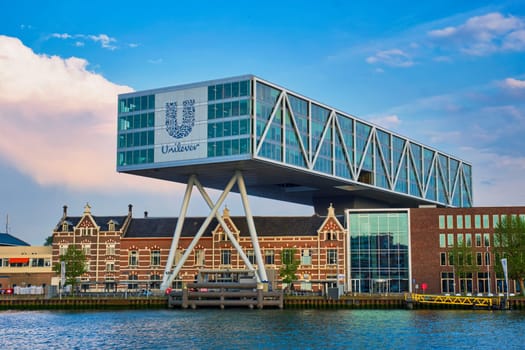 ROTTERDAM, NETHERLANDS - MAY 11, 2017: Unilever Bestfoods headquarters building De Brug (The Bridge) built over an existing historical factory from 1891 designed by architect Chris de Jonge