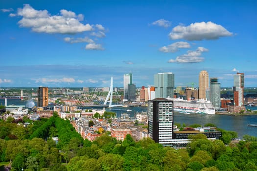 ROTTERDAM , NETHERLANDS - MAY 14, 2017: View of Rotterdam city and the Erasmus bridge Erasmusbrug over Nieuwe Maas river with cruise liner from Euromast