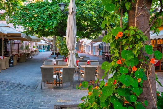 Street cafe in scenic picturesque streets of Chania venetian town with coloful old houses. Chania greek village in the morning. Chanica, Crete island, Greece