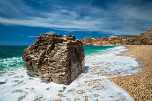 Rocks on Paleochori beach and waves of Aegean sea, Milos island, Cyclades, Greece. Slow motion