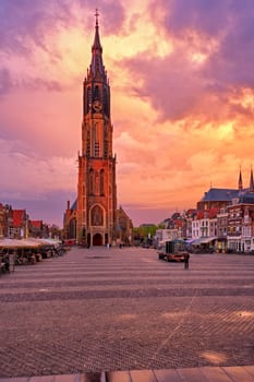 Nieuwe Kerk New Church protestant church on Delft Market Square Markt with dramatic sky on sunset. Delft, Netherlands