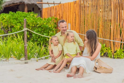 A joyful family, two girls, dad, and a pregnant mom, bask in tropical beach bliss, celebrating a radiant pregnancy amidst paradise.