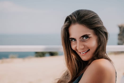 Happy woman portrait in cafe. Boho chic fashion style. Outdoor photo of young happy woman with long hair, sunny weather outdoors sitting in modern cafe